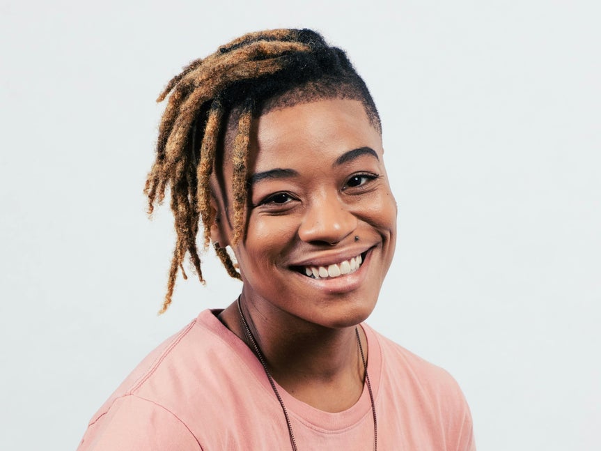 Portrait of a smiling person before touch up, with natural skin texture and lighting