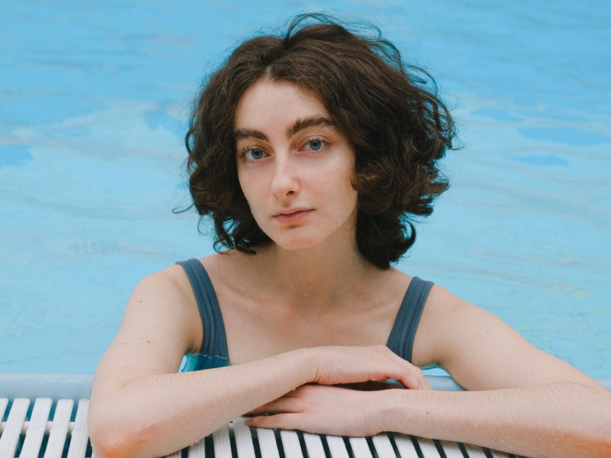 Natural portrait of woman in pool before applying any touch up enhancements