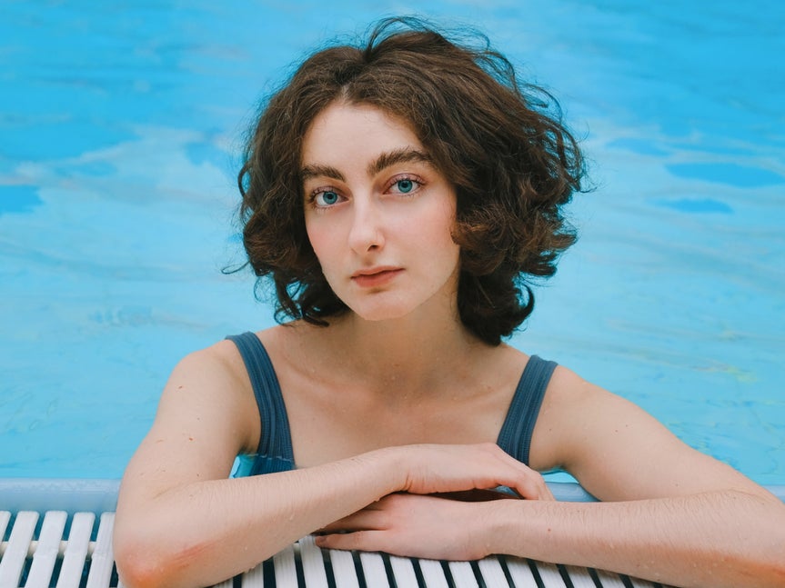 Edited portrait of woman in pool after applying digital makeup with BeFunky's touch up tools